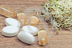 Sprouts as source vitamins and tablets supplements. Choice between healthy eating and pills. Alternative medicine