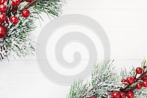 Spruce branch tree branches with Christmas decor on a white wooden background. Christmas, New Year`s concept. Top view, close-up.