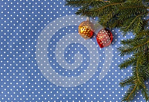 Spruce branches with Christmas tree toys in the form of nuts on a background of cloth in polka dots