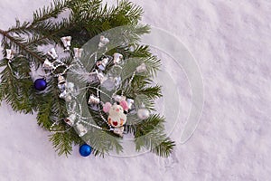 Spruce branches with toys, as well as a symbol of the year, a mouse in the snow