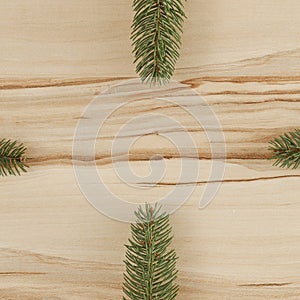 Spruce twigs and baubles on a wooden table flat background. Christmas decorations on wooden board top seen from above.