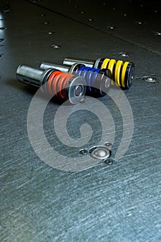 Sprung metal punches