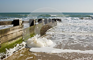 Spume on groyne, Dorset