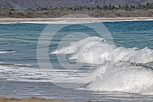 Spume waves going to the mexican pacific ocean beach photo