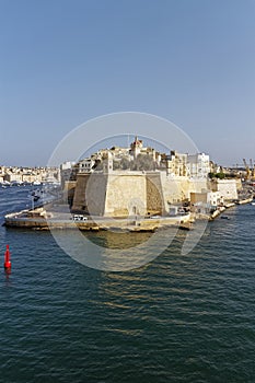 The Spur and its associated red Navigation Buoy in front of it, in Valetta Harbour on the Island of Malta