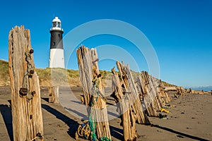 Spurn Point lighthouse and old wooden beach sea defences