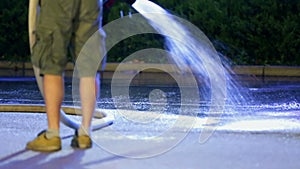 Spurting the water on the concrete surface at night