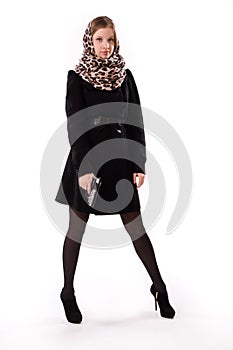 Spy girl in a black coat with gun