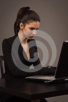 Spy girl in a black with laptop