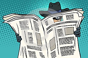 Spy watches through the newspaper photo