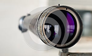 Spyglass in the shooting range to watch the target hit The shooting range instructor looks through the telescope at the target