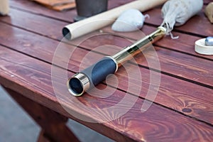 Spyglass on wooden table, brass handheld telescope