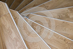 Spyral wooden staircase closeup. Interior design concept