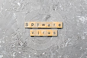 Spyware virus word written on wood block. Spyware virus text on cement table for your desing, concept