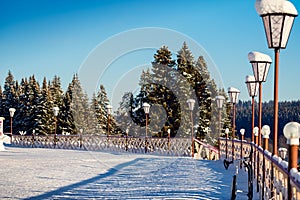 Sqare with snow and street lamps photo