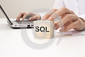 sql - sales qualified lead text wooden block on white table background. Idea, strategy, advertising, marketing, keyword