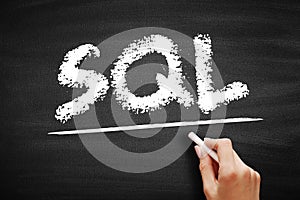SQL Structured Query Language - standardized language for defining and manipulating data in a relational database, acronym text on