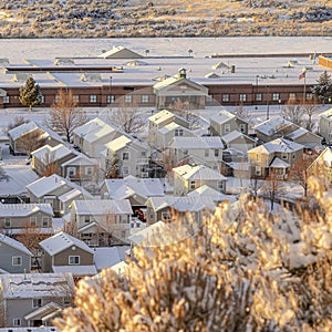 Square Aerial view of building and houses against a white landscape of fresh snow