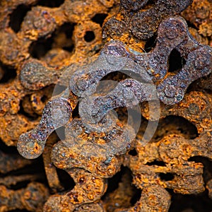 Square background with rusty industrial roller chain, soft focus