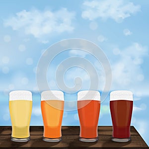 Square banner with craft beer in pilsner glasses. Wooden table against the background of the sea and blue sky. Light and