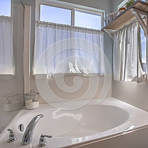 Square Bathroom interior with close up view of the gleaming built in bathtub