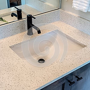 Square Bathroom white countertop with single basin undermount sink and black faucet