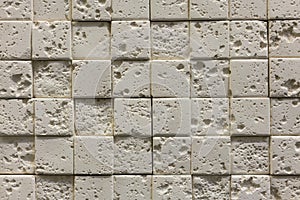 Square beige pebbles for decoration. Stone background