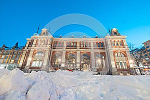 Square in bergen ar night, one of many hotels and houses covered in snow and ice. Colorful houses aroud lit by streetlamps and