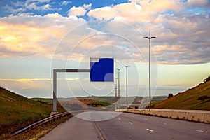 Square blank billboard over a rural national motorway