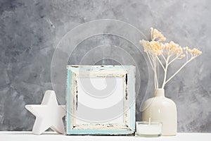 Square blue Photo frame mock up with dry beige plants in vase, ceramic decor on shelf. Scandinavian style