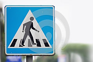 Square blue traffic sign for pedestrian crossing