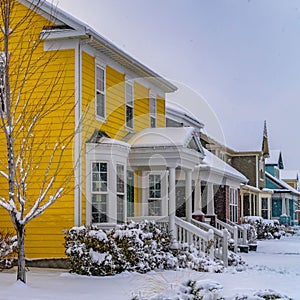 Square Charming homes on a snow covered landscape during winter in Daybreak Utah