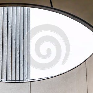 Square Close up of circular skylight with view of the concrete building exterior wall