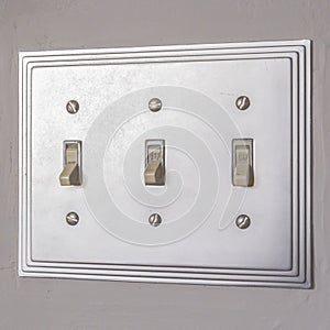 Square Close up of the electrical light switch against the white wall of a house