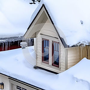 Square Close up of Park City Utah home with icicles and thick layer of snow on the roof
