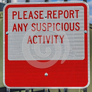 Square Close up of a sign that reads Please Report Any Suspicious Activity