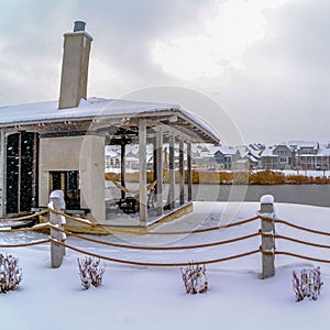 Square Clubhouse overlooking lake and homes against cloudy sky on a frosty winter day