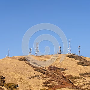 Square Communication towers on a mountain top day light