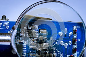 A square computer processor pulled from a broken computer. The processor is on the table.