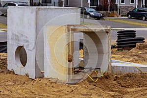 The square concrete blocks with hole in the center, installed in preparation for sewage under the ground