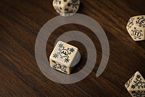 Square cream colored gaming dice on wood