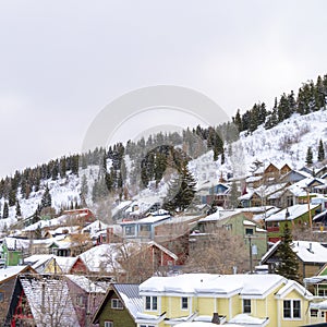 Square crop Park City residential community with colorful home cabins on snowy mountain