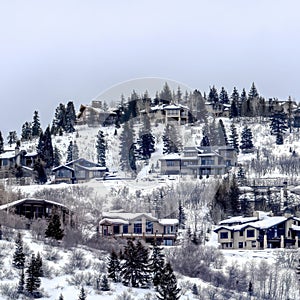 Square crop Park City Utah neighborhood in winter with colorful homes on snowy hill top