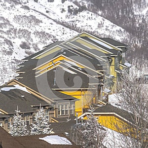 Square crop Rows of snowy houses built on the frosted slope of Wasatch Mountains in winter