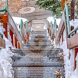 Square crop Stairway going down to a road on a hill with fresh white snow in winter