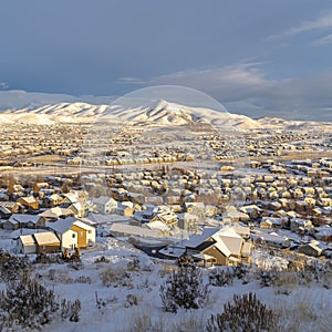 Square crop Sunset in scenic Utah Valley with homes and mountain covered with winter snow