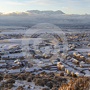 Square crop Sunset in Utah Valley with homes on a snowy neighborhood with mountain view