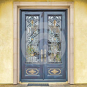 Square Double door with decorative wrought iron and glass panes at the house entrance