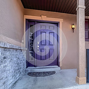 Square Entrance of home with stairs leading to porch and purple front door with wreath
