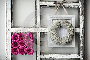 A square of flowers on a window frame.